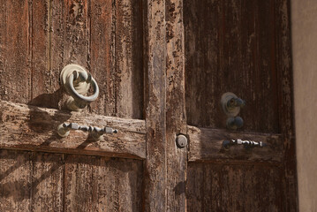 Old wooden door outdoors on sunny day, closeup