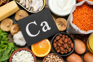 Set of natural food high in calcium on wooden table, flat lay