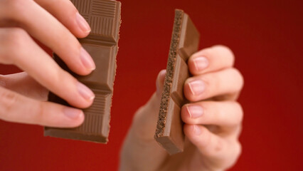 Man breaking chocolate. Stock footage. Close-up of hands breaking chocolate bar into two parts....