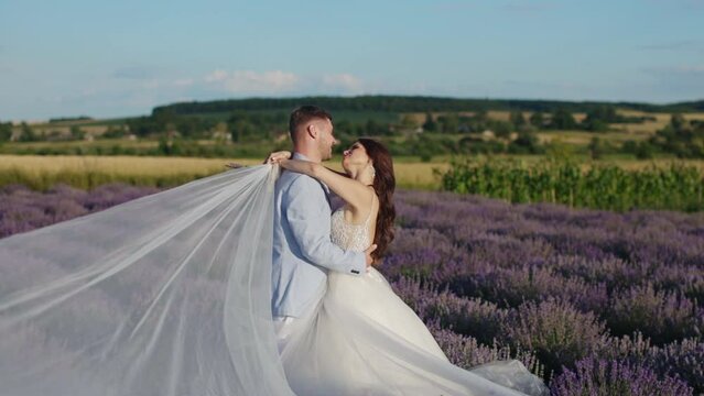 newlyweds in love embrace tenderly in a lavender field