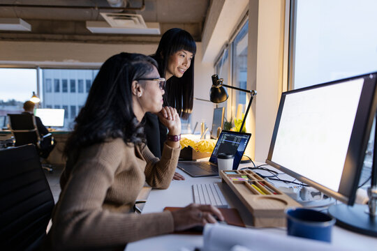 Female Architects Working At Computer In Office