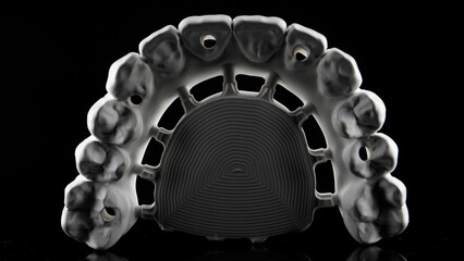 Creative dental photo of the milling dental of Zircon for the future prosthesis of the upper jaw on a black background © Dental Pro Content