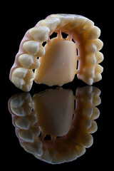 A great angle of Dental of Zircon as one of the stages of the prosthesis on the black glass with...