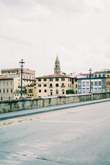 Asphalt road with lanterns against the backdrop of old houses in Florence