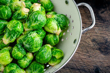 Freshly Washed Brussels Sprouts in a Colander: Overhead view of wet Brussels sprouts with water drops in a strainer