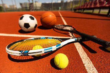 Set of sport equipment, rackets and tennis balls soccer and basketball balls