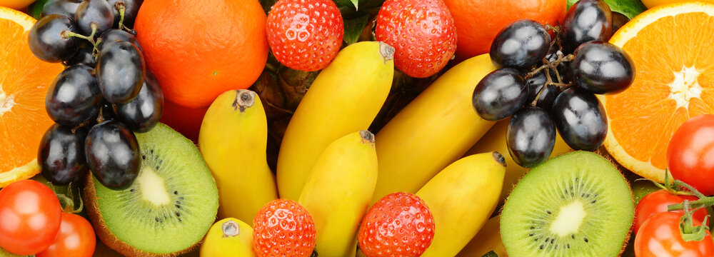 Bright background from a set of fruits. Wide photo.