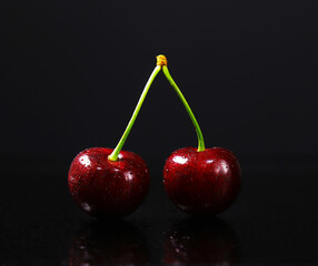 Sweet cherry in small drops on a dark background. Shallow depth of field