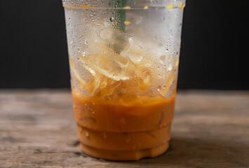 Ice milk tea sweet drink blurred on black