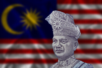 Tunku Abdul Rahman on the background of the Malaysian flag. The portrait of the Prime Minister on the Malaysian one ringgit banknote.