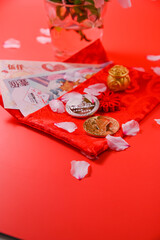 chinese new year festival decoration pow or red pack, orange and gold ingots or golden wad on red...