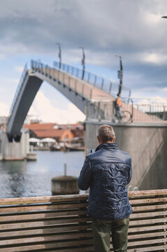 attractive old man walking in the city  lifestyle portrait with Tonsberg viewpoint