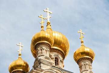 Fototapeta na wymiar Golden domes of the Church of St. Mary Magdalene in Jerusalem. Orthodox church on sky background