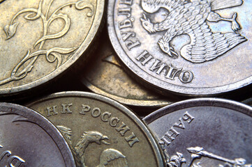 Russian rubles in the form of metal coins lie on a yellow background. close-up.