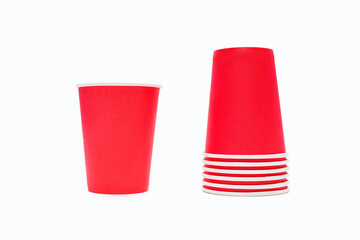 Stack of red disposable cardboard coffee cups isolated on white background. Disposable cups for coffee and drinks. The concept of a holiday or fast food and drinking coffee and tea