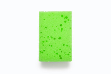 A green embossed washcloth on a white background in the center of the image. Washcloth for washing dishes and daily cleaning in the house. The concept of cleanliness and care in the house