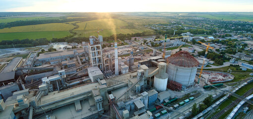 Aerial view of cement factory tower with high concrete plant structure at industrial production...