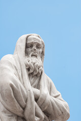 Fototapeta na wymiar marble sculpture - a man with a beard in a cape, waist up