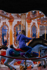 A girl in a carousel at night