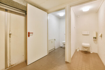 Modern toilet installed on beige wall under button and illuminated shelf in light restroom at home