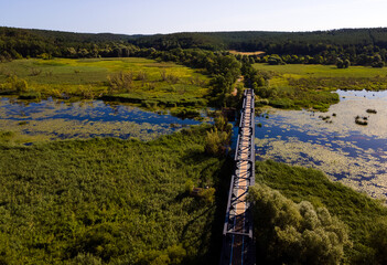 Siekierki, Zachodniopomorskie / Poland - August 01 2022 Tourist bridge on foot on a bicycle on the...
