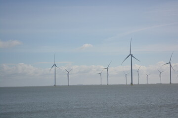Wind turbines at Amstelmeer, Netherlands. Dutch windmill park in the North sea. Space for text.