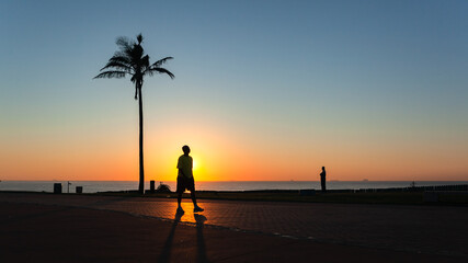 Beach Ocean Sunrise Horizon People Walking Silhouetted Lifestyle Landscape.