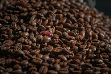 Grains of delicious roasted coffee in a manual mechanical coffee grinder.