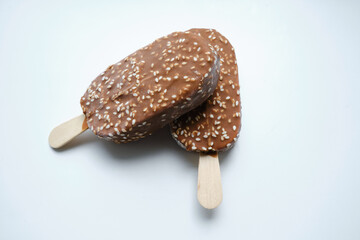 Ice cream in chocolate glaze on a light background. Natural ice cream close-up. Summer sweet delicious cold dessert. traditional dairy product
