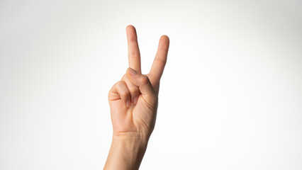Women's hands gesture counting on fingers two palm side