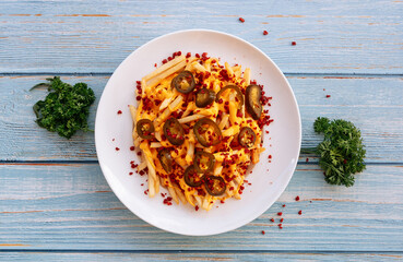 loaded Cheesy Fries Served in dish isolated on wooden table top view fastfood