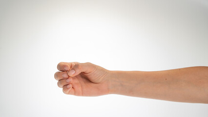 Hand woman gesture fingers clenched into a ring holding a cylindrical object