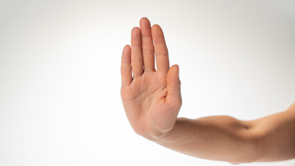 woman's hand with forearm gesture stop on a white background