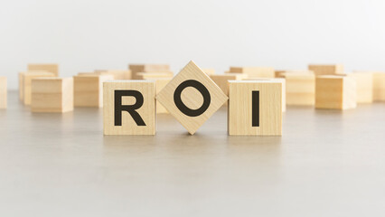 word ROI is made of wooden blocks on white background