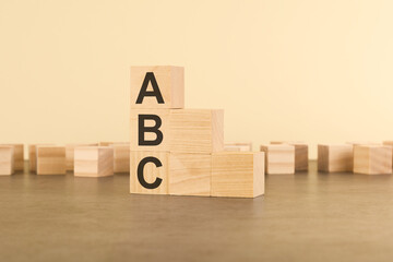 text ABC on stairs wooden blocks. Small steps towards goal or step by step to success concept.