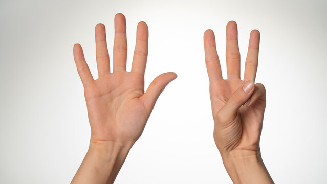 Women's hands gesture counting on fingers eight palm side