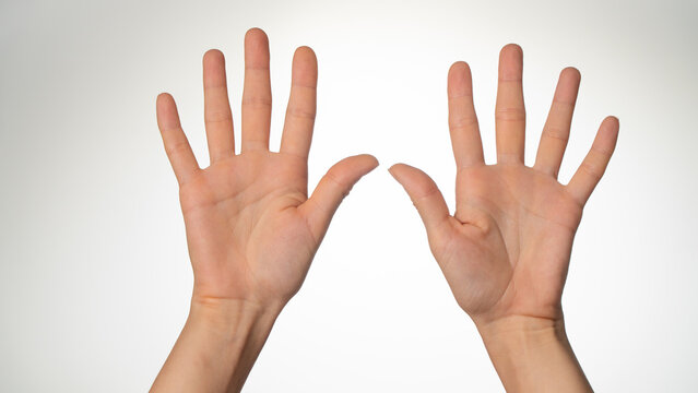Women's hands gesture counting on fingers ten palm side