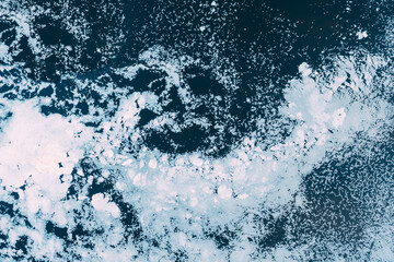 Natural background of ice on the river. Textured cold frosty surface of ice on the river. Ice...