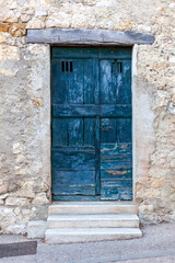 Fototapeta na wymiar Blue wooden exterior door in a small european village