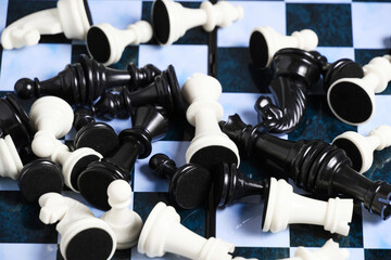 Scattering black and white chess pieces chessboard.