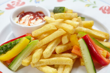 french fries with sauce and vegetables