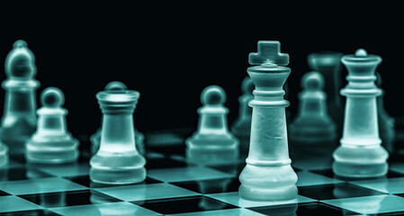 Glass chess on chess board. Close up with the black background