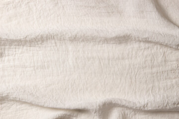 Fototapeta na wymiar White crumpled fabric texture background. Natural organic eco textiles canvas banner background. Top view
