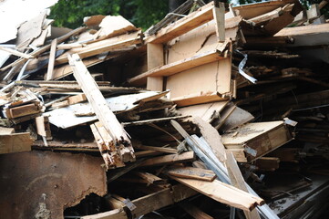 Debris and wooden remains and garbage pile on a stack on demolition site of a building