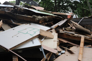 Debris and wooden remains and garbage pile on a stack on demolition site of a building