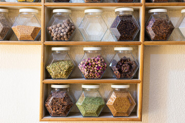 Many different colorful glass recipients in a row with different spices clours in a shop in Marrakesh