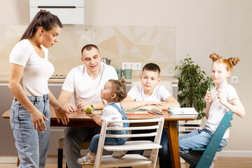 young family with three children in the kitchen