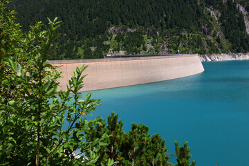 Fototapeta na wymiar Vivid blue mountain lake in summer Alps. Speicher Zillergrundl dam, Zillertal Alps, Austria