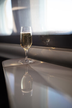 Interior of first class airplane with champagne glass for flight