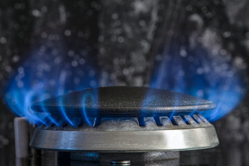 Combustion of natural gas, propane. Gas stove on a black background. Fragment of a gas kitchen...